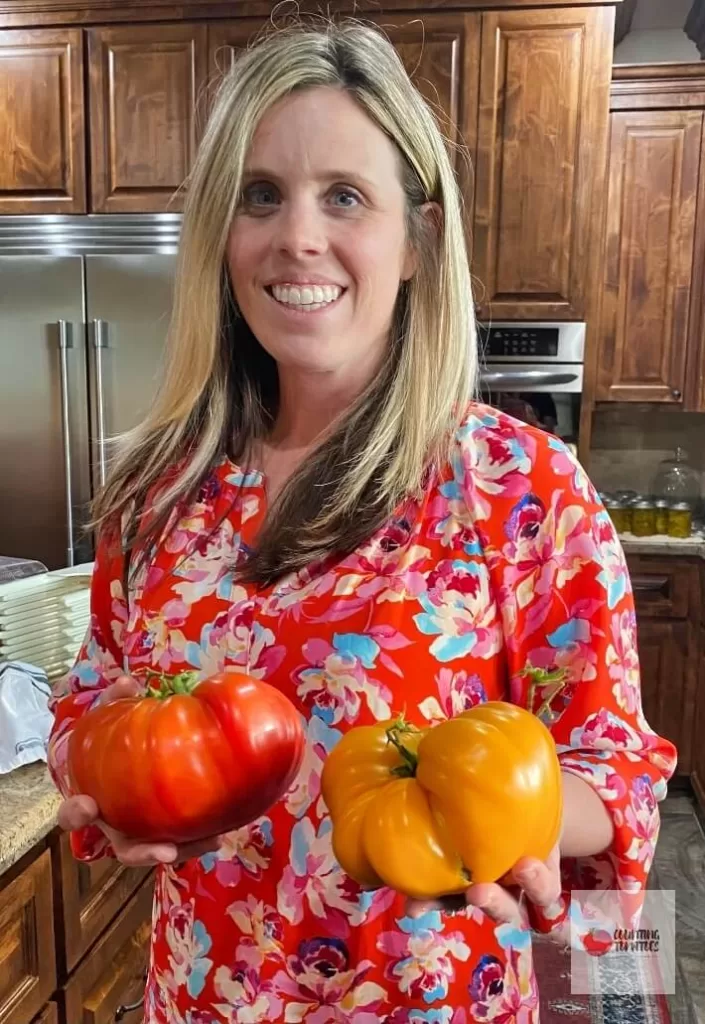 Woman holding two tomatoes